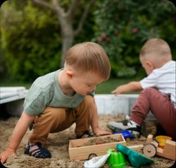 two kids playing in a sandbox