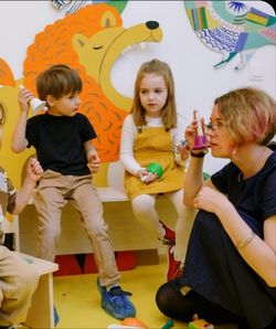 two preschoolers and a teacher learning