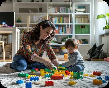 Teacher and boy playing with blocks