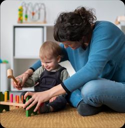 Infant playing with teacher