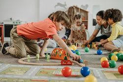 Preschool boy playing with train