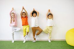 three preschool kids doing yoga