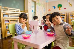 three toddlers eating